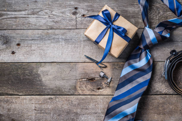 Father's day concept - present, tie on rustic wood background Father's day concept - present, tie on rustic wood background, top view necktie stock pictures, royalty-free photos & images