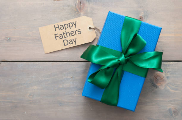 Fathers day gift Fathers day gift box wrapped with silk ribbon with greeting fathers day stock pictures, royalty-free photos & images