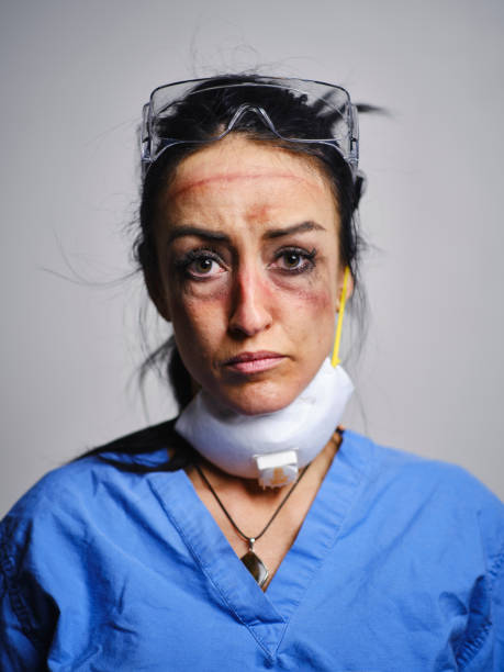 Fatigued Healthcare Worker A healthcare worker showing the signs of fatigue from working long hours combatting communicable disease in a hospital. nurse face stock pictures, royalty-free photos & images