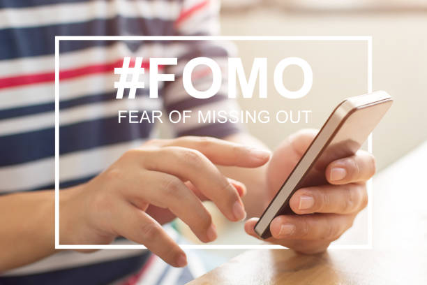 FOMO, fear of missing out concept. Close-up image of male hands using mobile smartphone FOMO, fear of missing out concept. Close-up image of male hands using mobile smartphone fomo photos stock pictures, royalty-free photos & images