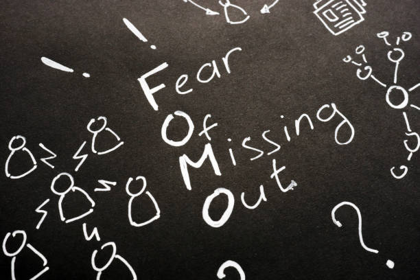 FOMO - Fear Of Missing Out sign on black sheet. FOMO - Fear Of Missing Out sign on black sheet. fomo photos stock pictures, royalty-free photos & images