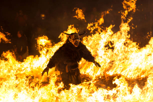 Fearsome Krampus character walking in fire stock photo
