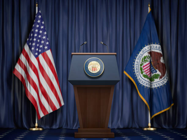 Federal Reserve System Fed of USA chairman press conference concept. Tribune with symbol and flag of FRS and United States. Federal Reserve System Fed of USA chairman press conference concept. Tribune with symbol and flag of FRS and United States. 3d illustration federal reserve stock pictures, royalty-free photos & images