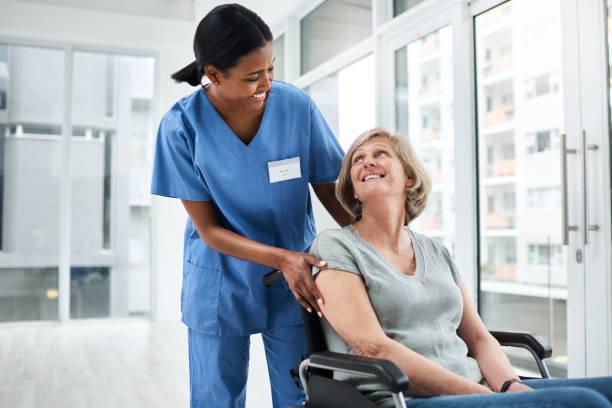 I feel right at home here Shot of a young nurse caring for a senior woman in a wheelchair leaving stock pictures, royalty-free photos & images