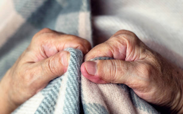 Feeling cold. Hands of elderly person feeling cold. stock photo