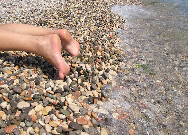 Feet near water stock photo