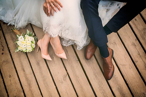 feet of bride and groom, wedding shoes (soft focus). stock photo