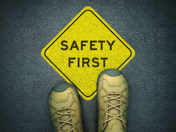 Feet on Asphalt Road with SAFETY FIRST Road Sign - 3D Rendering Feet on Asphalt Road with SAFETY FIRST Road Sign - 3D Rendering safe stock pictures, royalty-free photos & images