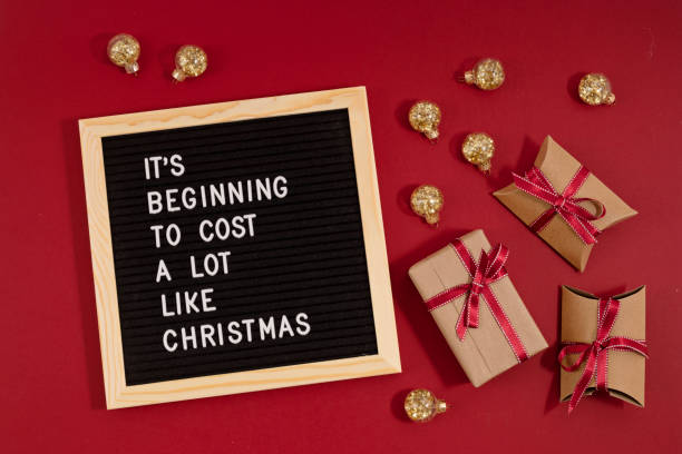 Felt letter board with funny quote text It is beginning to cost a lot like Christmas stock photo
