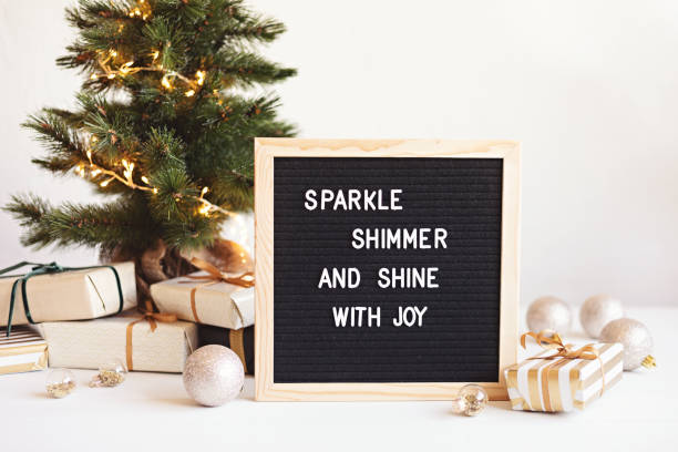Felt letter board with text sparkle, shimmer and shine with joy and christmas gifts, decoration stock photo