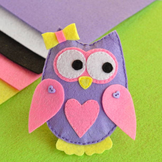 Felt owl ornament, sheets of felt on a green background. Cute felt owl ornament. Sewing projects for kids. Felt crafts for kids stock photo