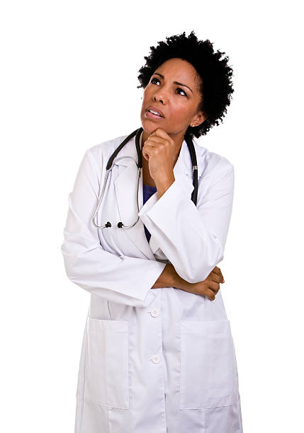 Female African descent doctor looking up making a face stock photo