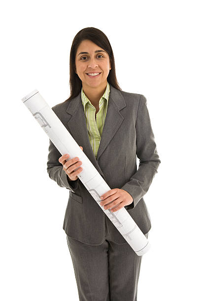 Female architect wearing suit holding blueprints stock photo