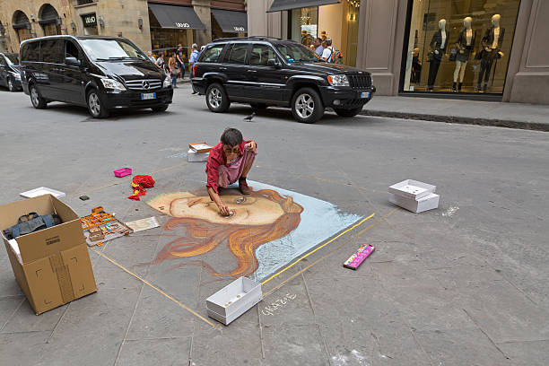 Female artist painting The Birth of Venus on pavement, Florence Florence, Italy - September 21, 2016: Female artist painting The Birth of Venus on pavement near Calimala street in Florence, Italy. botticelli stock pictures, royalty-free photos & images