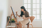 istock Female Asian painter creating art in her home studio 1333303020