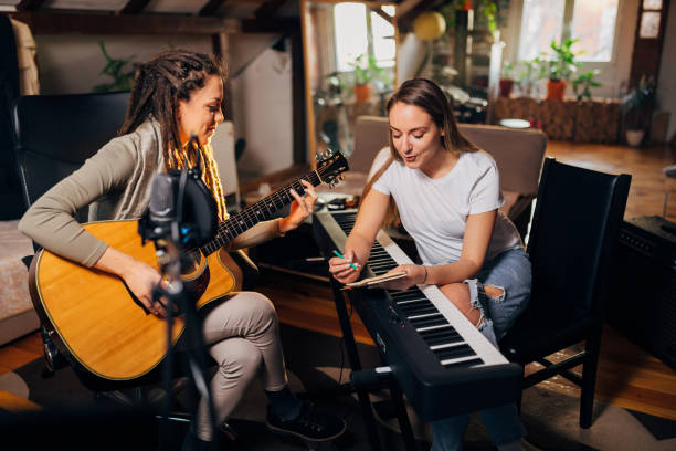 Female band, spending the creative time in the music studio, while working on a new song stock photo
