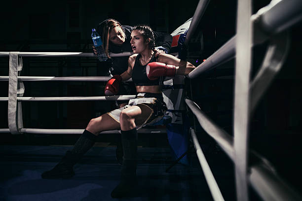 Female boxer in a boxing ring stock photo