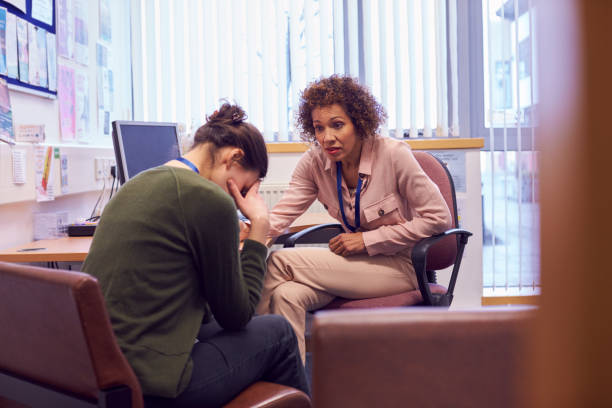Female College Student Meeting With Campus Counselor Discussing Mental Health Issues Female College Student Meeting With Campus Counselor Discussing Mental Health Issues school counselor stock pictures, royalty-free photos & images