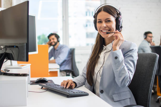Female customer support operator working in call center. Help and technical support concept. stock photo