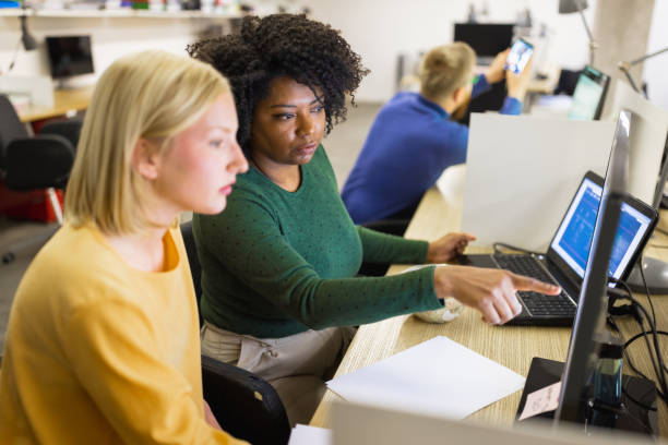 Female cybersecurity experts working on protecting company stock photo