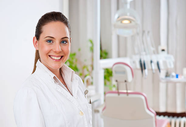 Female dentist smiling for portrait at her practice stock photo