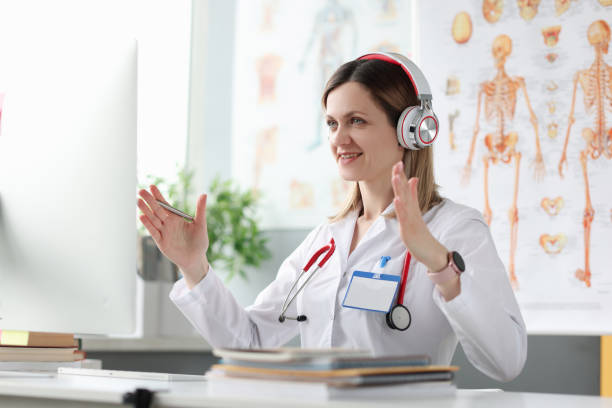 Female doctor conducts remote medical online consultation Female doctor conducts remote medical online consultation. Remote healthcare for remote patients and telemedicine concept nurse talking to camera stock pictures, royalty-free photos & images