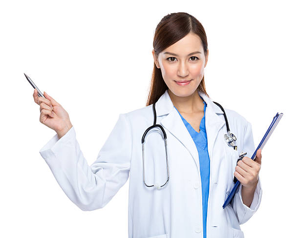 Female doctor holding a clipboard and pointing stock photo