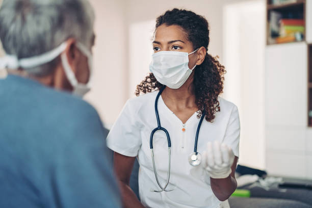 Female doctor talking with a senior patient Doctor and a senior patient general practitioner stock pictures, royalty-free photos & images