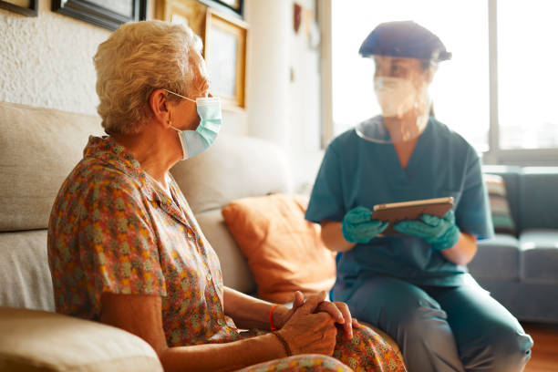 A female doctor visits a senior woman at the nursing home. Testing covid at home at home covid test stock pictures, royalty-free photos & images
