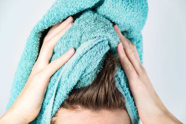 Female drying her hair with towel stock photo