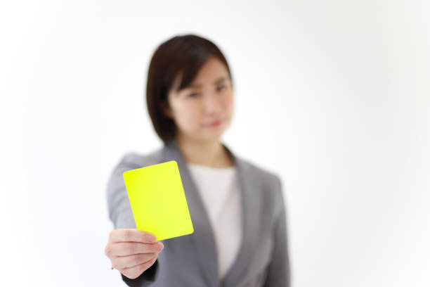 Female employee issuing a yellow card stock photo