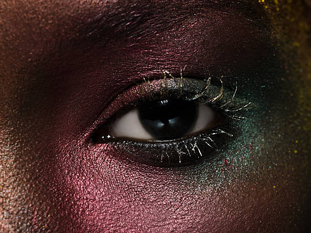Female eye covered in metallic make up  brown eyes stock pictures, royalty-free photos & images