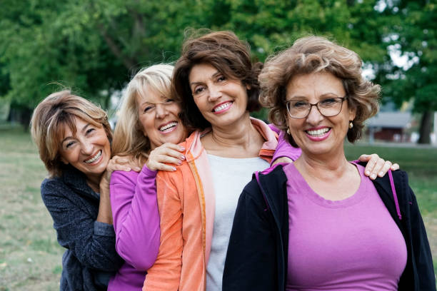 Female Friends over fifty exercising outdoors stock photo
