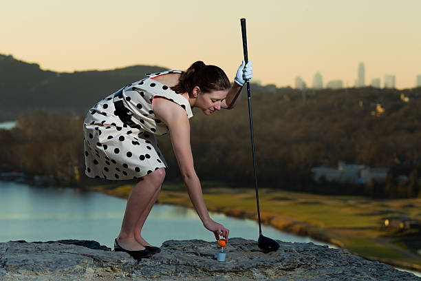 Female Golfer Teeing up her Ball stock photo
