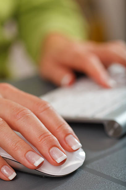 Female hand on computer mouse stock photo