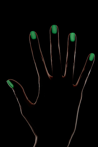 Download Female Hand Silhouette With Phosphorescent Nail Polish ...
