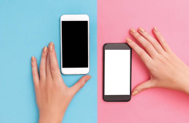 female hands hold two phones black and white stock photo
