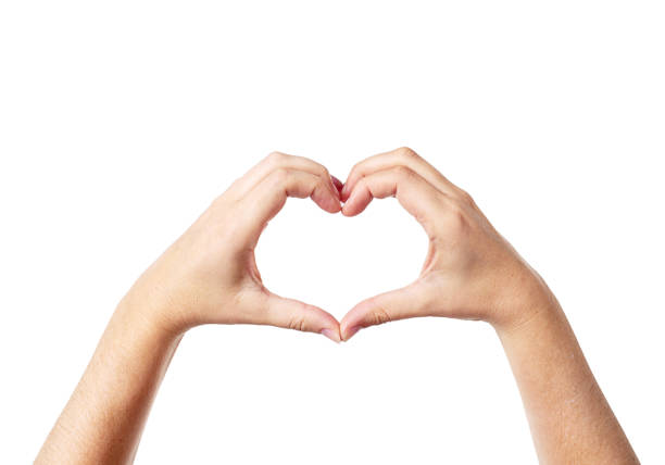 A woman's hands make a heart shape against a white background.