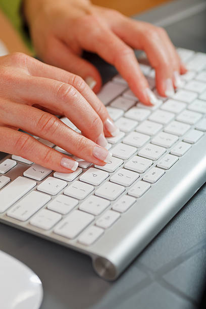 Female hands typing stock photo