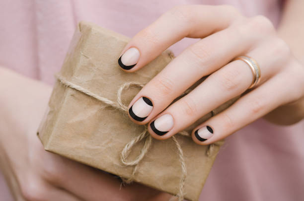Female hands with black french nail design. stock photo