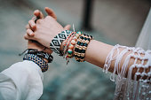 istock Female hands with bohemian accessories bracelets made of colored beads 1326141621