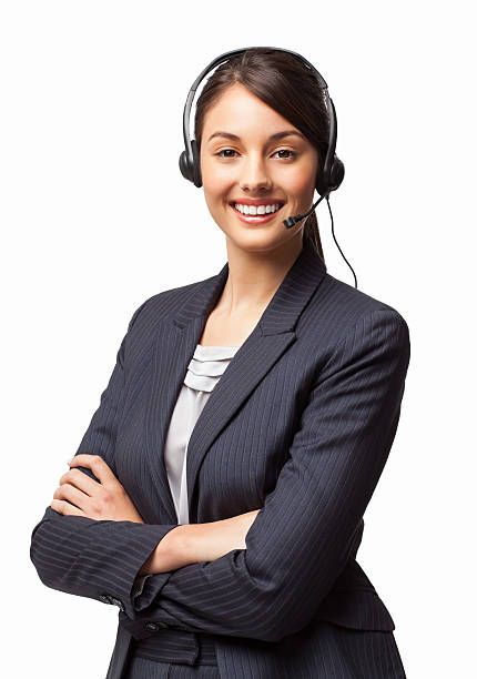 Female IT Helpdesk Manager Smiling With Arms Crossed - Isolated Portrait of happy young female IT helpdesk manager smiling with arms crossed. Vertical shot. Isolated on white. headset woman customer service stock pictures, royalty-free photos & images
