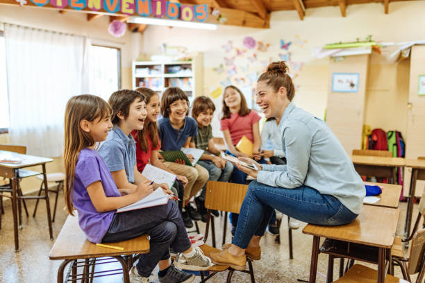 Female Latina teacher with Hispanic kids in classroom at school Elementary education in Latin America elementary school teacher stock pictures, royalty-free photos & images
