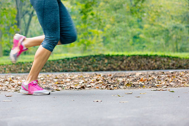 Close up of woman runnerâs legs running in park, training exercise. Little motion blur present. Canon 5D MK III