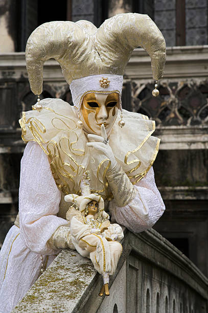Female mask with white Jester costume at carnival in Venice  harlequin stock pictures, royalty-free photos & images