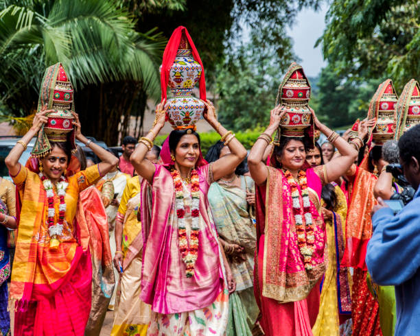 Female maternal relatives of Indian bridegroom enjoying traditional Jaggo ceremony before his wedding. stock photo