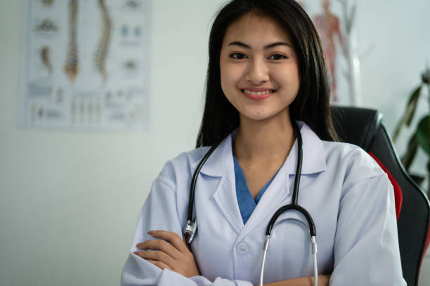 Female Medical Professional Using Technology for Meeting with Patients using Online Video Female Medical Professional Using Technology for Meeting with Patients using Online Video nurse talking to camera stock pictures, royalty-free photos & images