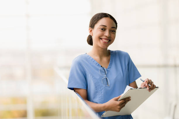 Female medical student smiles for camera before class stock photo
