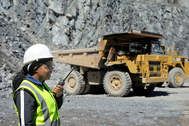 Female mine official oversees work stock photo