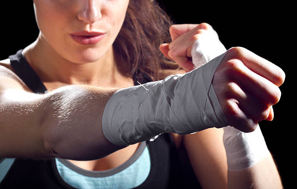 A female MMA fighter giving a strong punch stock photo